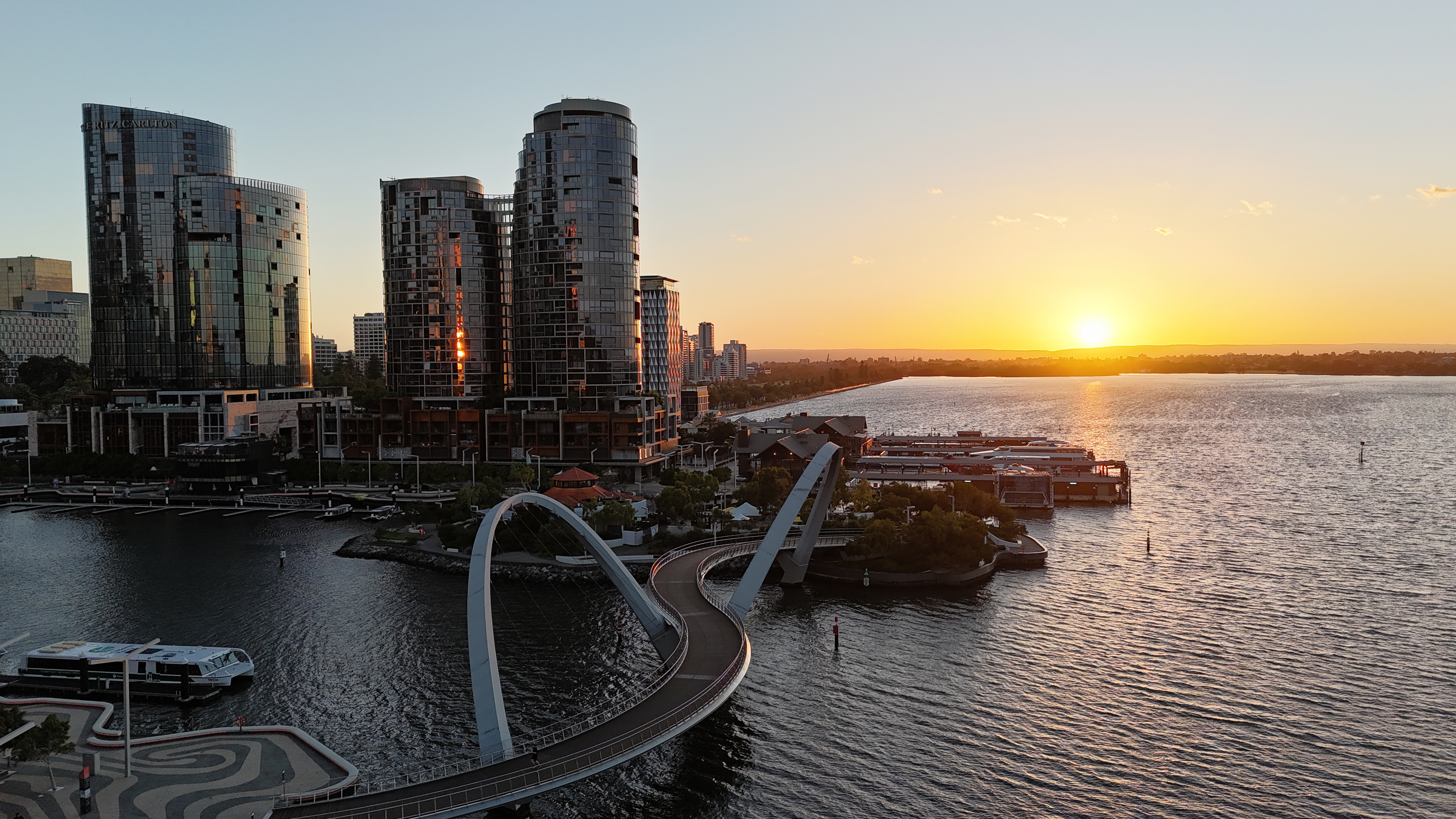 Perth CBD skyline at sunset with Elizabeth Quay bridge and Swan River